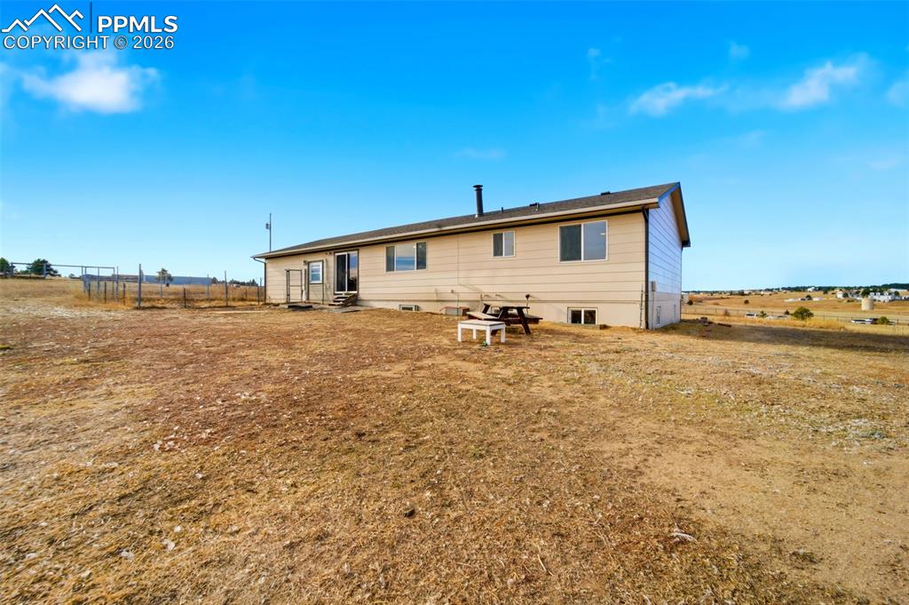 13815 Woodlake Road Elbert, CO 80106 - Photo 30 of 37 a view of a house with backyard and ocean view