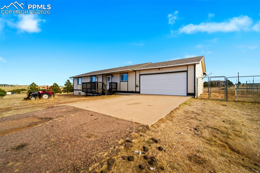13815 Woodlake Road Elbert, CO 80106 - Photo 3 of 37 a front view of a house with a yard