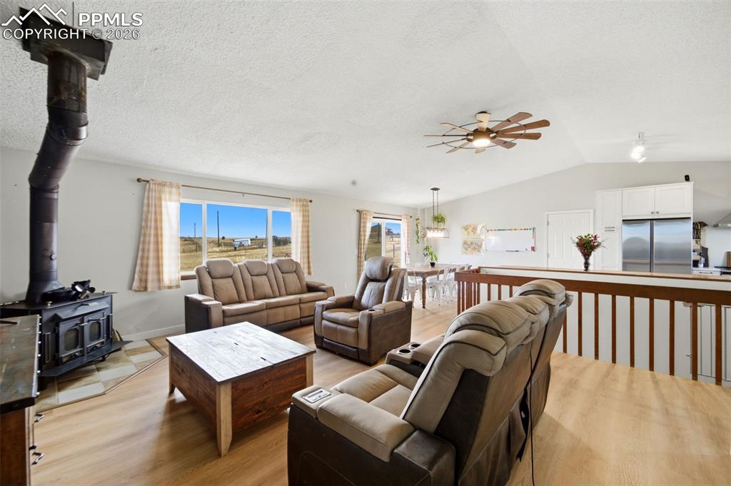 13815 Woodlake Road Elbert, CO 80106 - Photo 10 of 37 a living room with furniture a fireplace and a flat screen tv