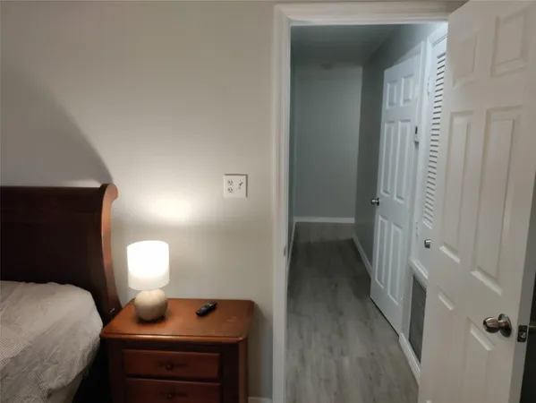 a bedroom with a bed and a lamp