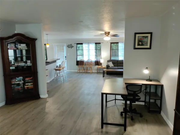 a living room with furniture and wooden floor