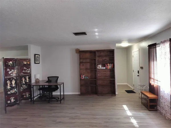 a view of a livingroom with furniture and an empty room
