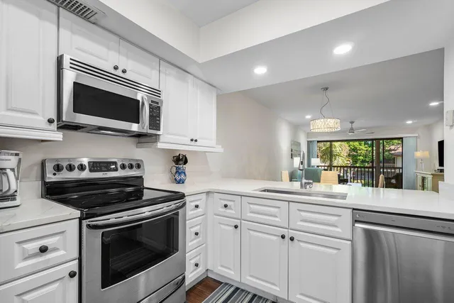 a kitchen with a sink stove and microwave