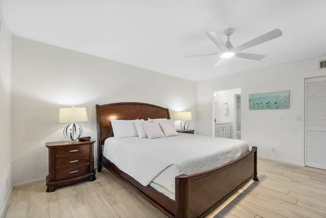 a bedroom with a bed and a ceiling fan