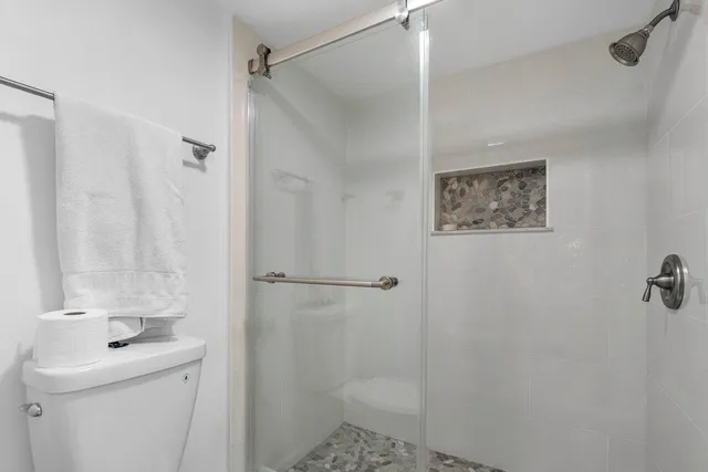 a bedroom with two large bed and a large window