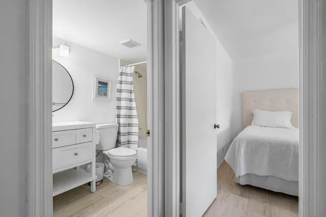 a bathroom with a sink a toilet and a mirror