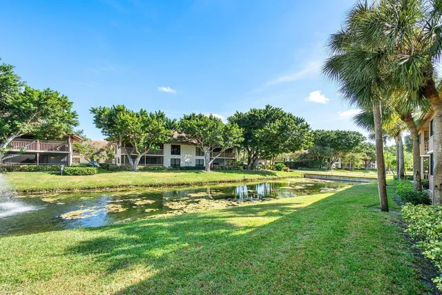 a view of a house with pool and a yard