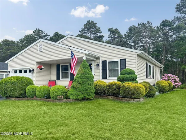 a front view of house with yard and green space