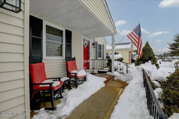 a view of a patio with dining table and chairs with wooden fence and plants