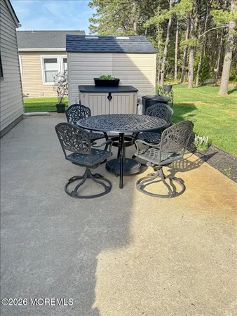 a view of a backyard with table and chairs