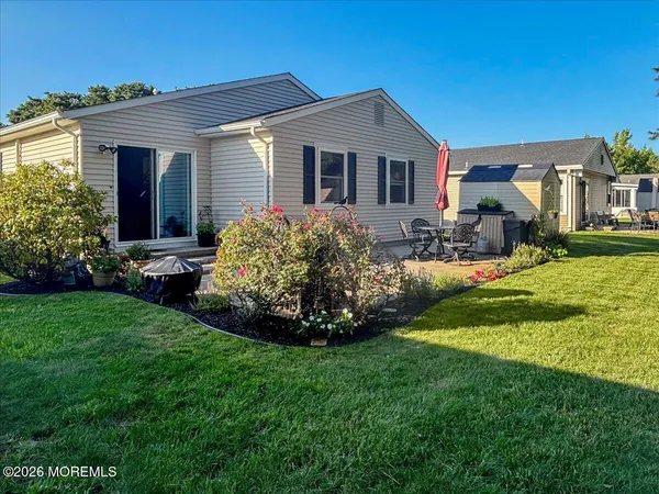 a view of a two chairs in the patio