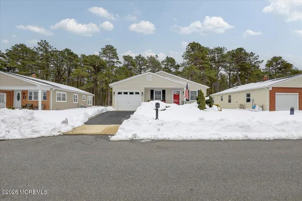 a view of large white house with a large space in front of it