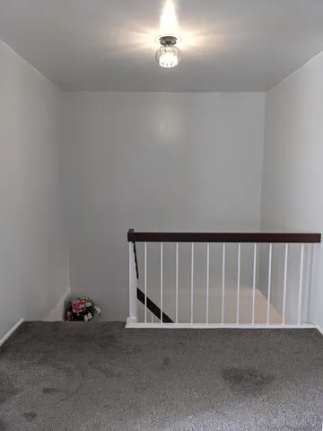 a bedroom with a bed and a ceiling fan