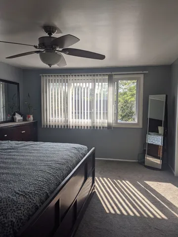 a view of walk in closet with clothes