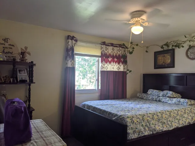 a view of a house with a wooden fence