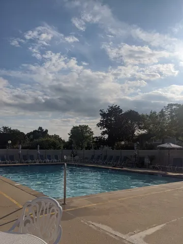 a front view of a house with a garden and yard
