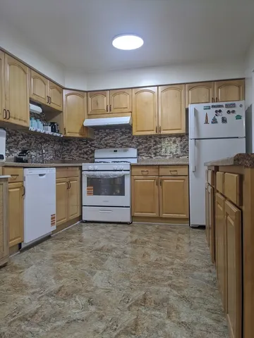 a stove top oven sitting inside of a kitchen