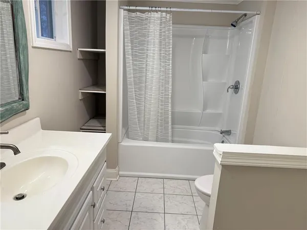 a bathroom with a sink a bathtub and a shower