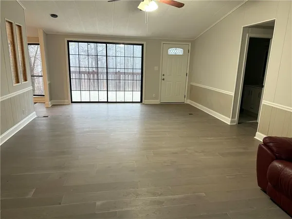 wooden floor in an empty room with a window