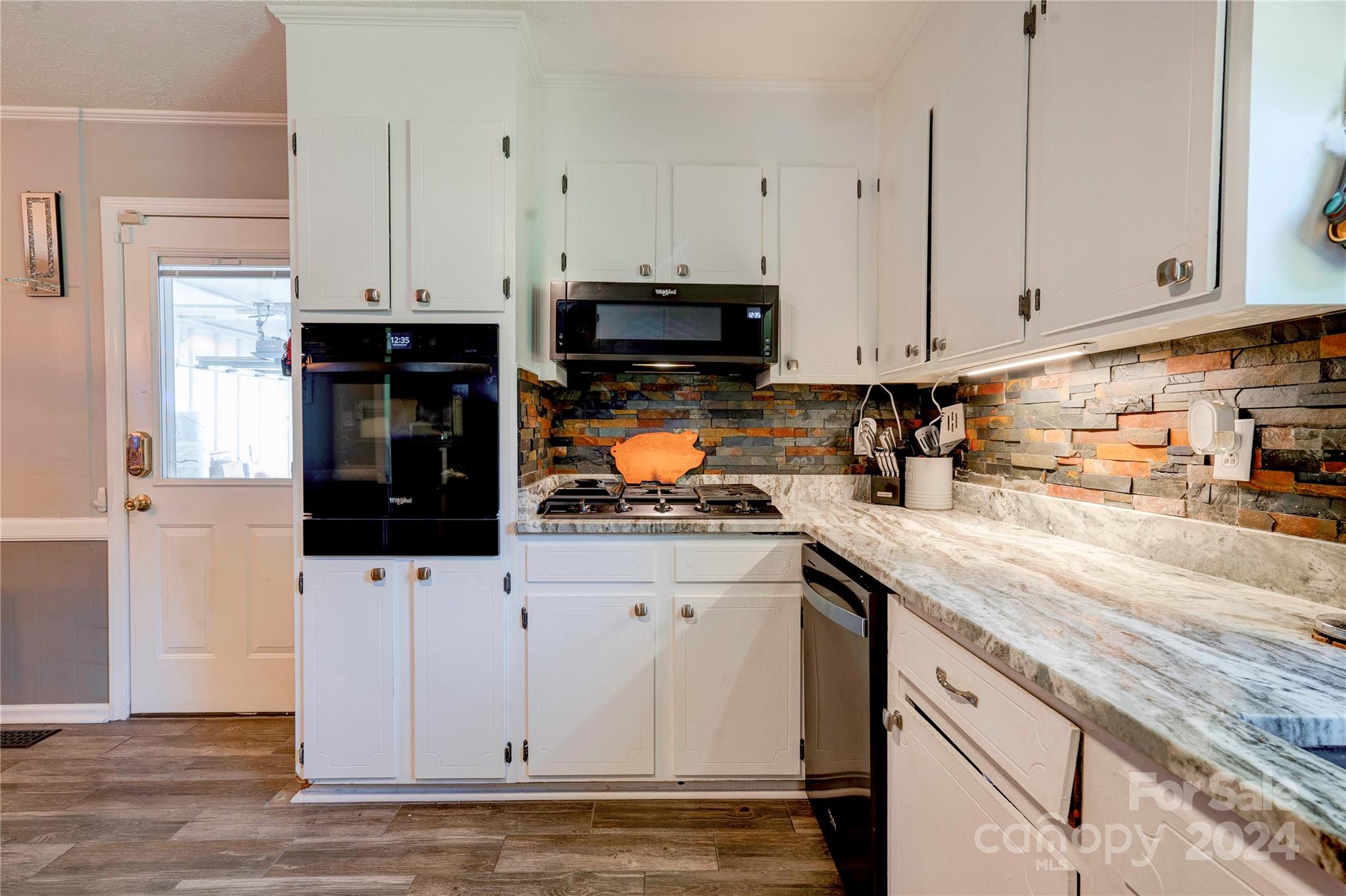 2352 Sheriff Allen Road Shelby, NC 28152 - Photo 13 of 48 a kitchen with granite countertop a sink a stove and cabinets