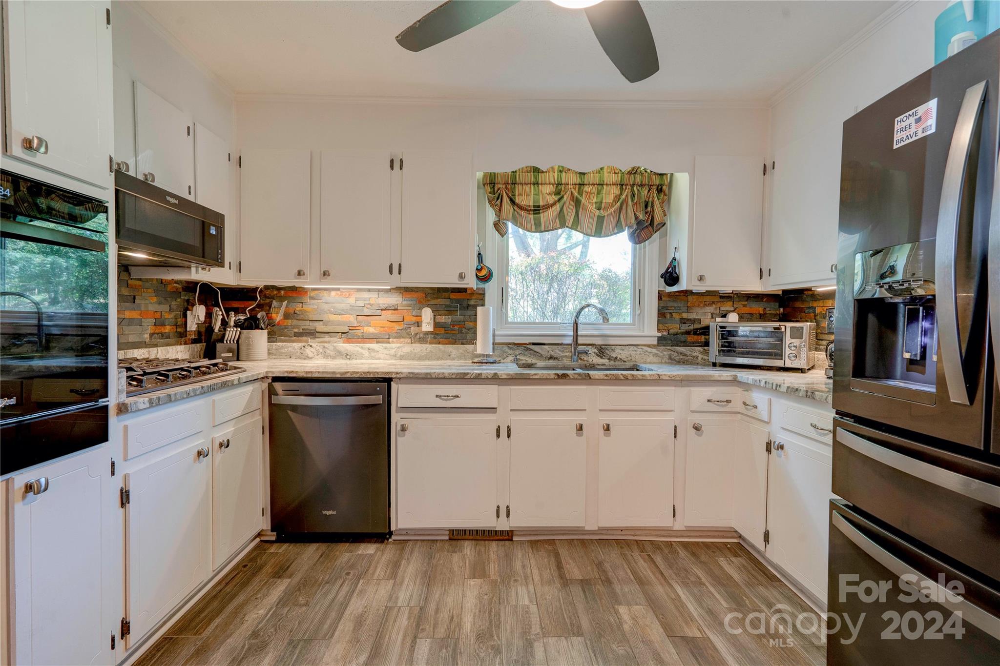 2352 Sheriff Allen Road Shelby, NC 28152 - Photo 16 of 48 a kitchen with granite countertop a sink cabinets stainless steel appliances and a counter space