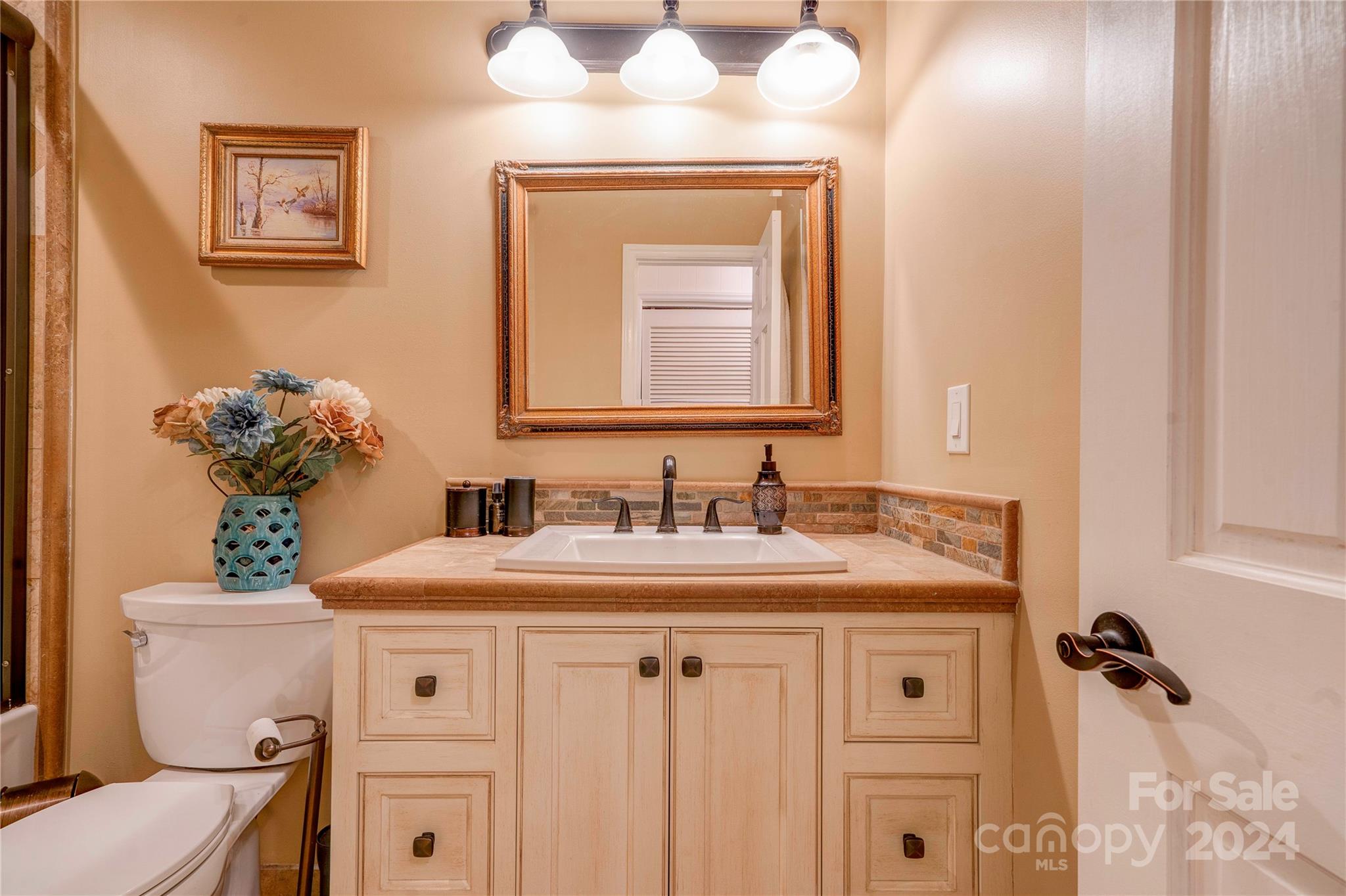 2352 Sheriff Allen Road Shelby, NC 28152 - Photo 32 of 48 a bathroom with a granite countertop sink vanity mirror and toilet