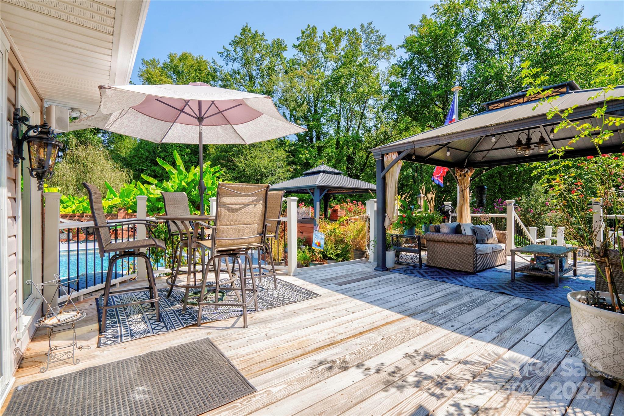 2352 Sheriff Allen Road Shelby, NC 28152 - Photo 39 of 48 a view of a patio with a table and chairs under an umbrella