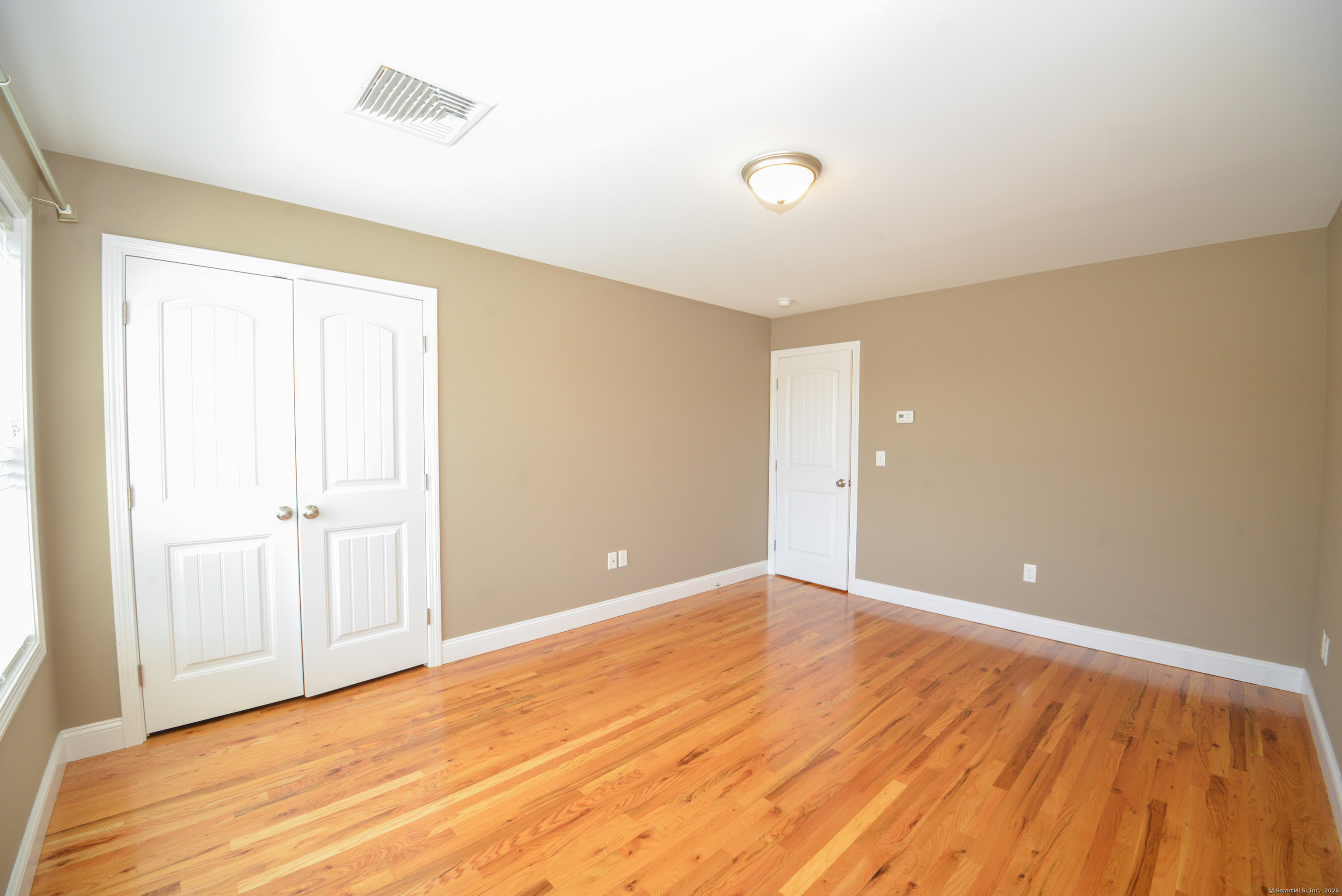 231 West Main Street, Unit C Milford, CT 06460 - Photo 12 of 18 a view of an empty room with wooden floor