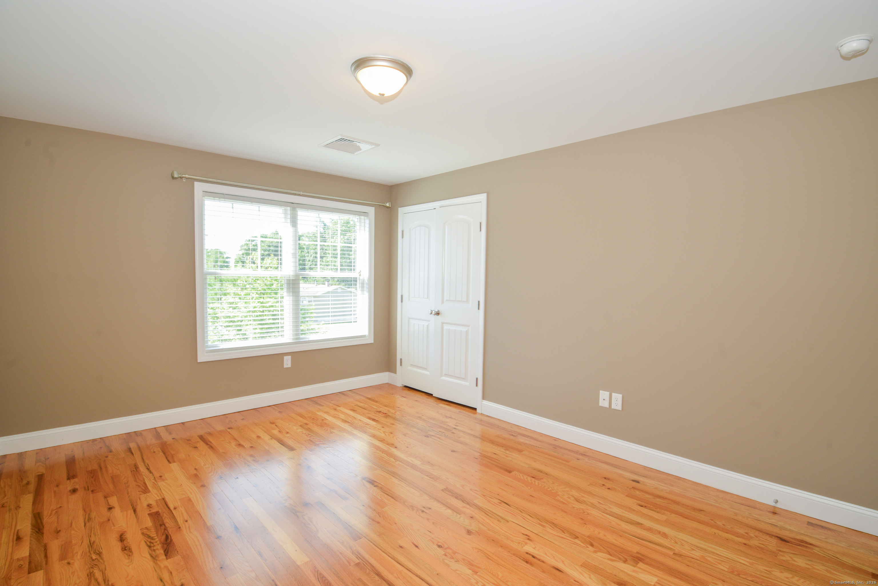 231 West Main Street, Unit C Milford, CT 06460 - Photo 14 of 18 an empty room with wooden floor and windows