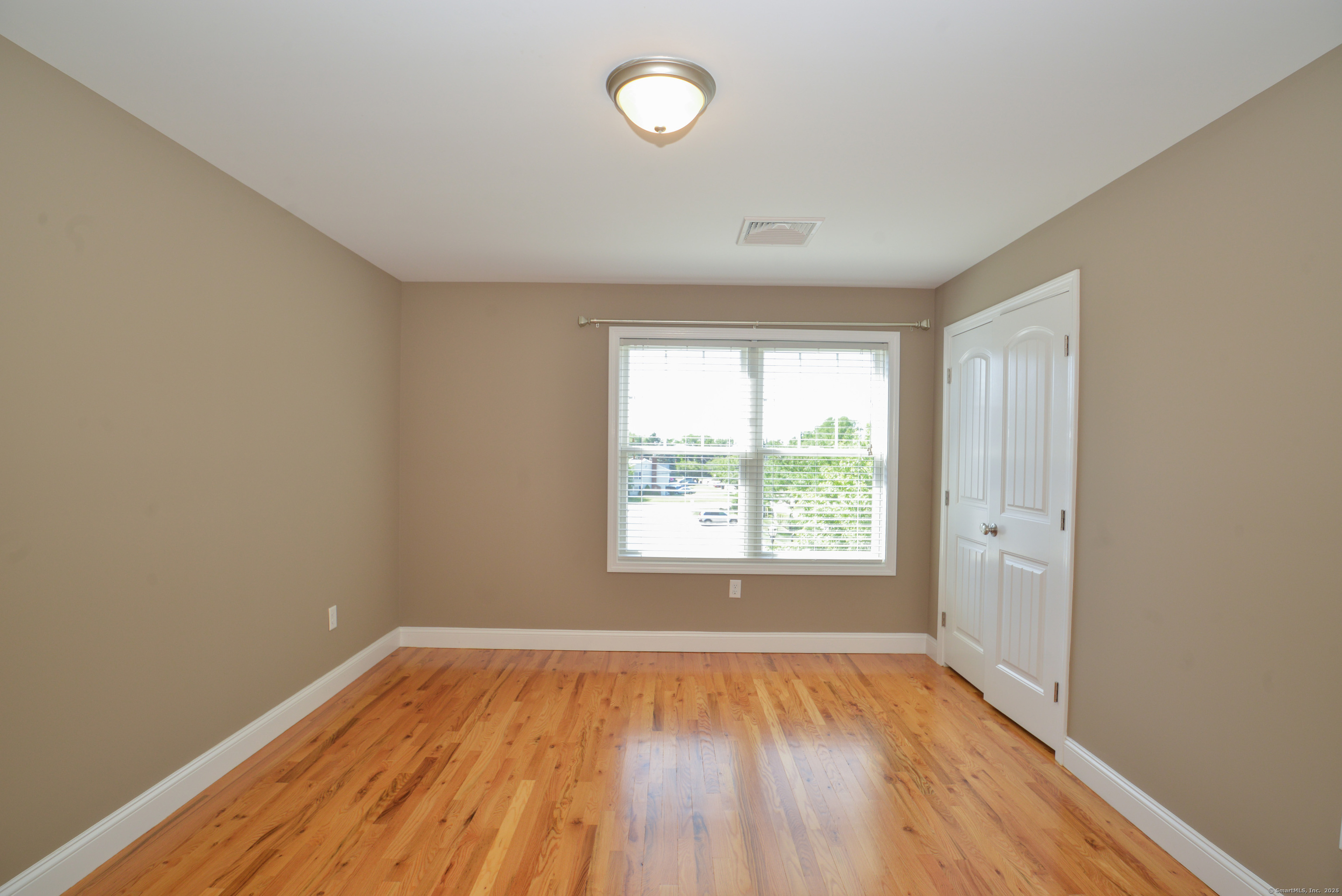 231 West Main Street, Unit C Milford, CT 06460 - Photo 15 of 18 an empty room with wooden floor and windows