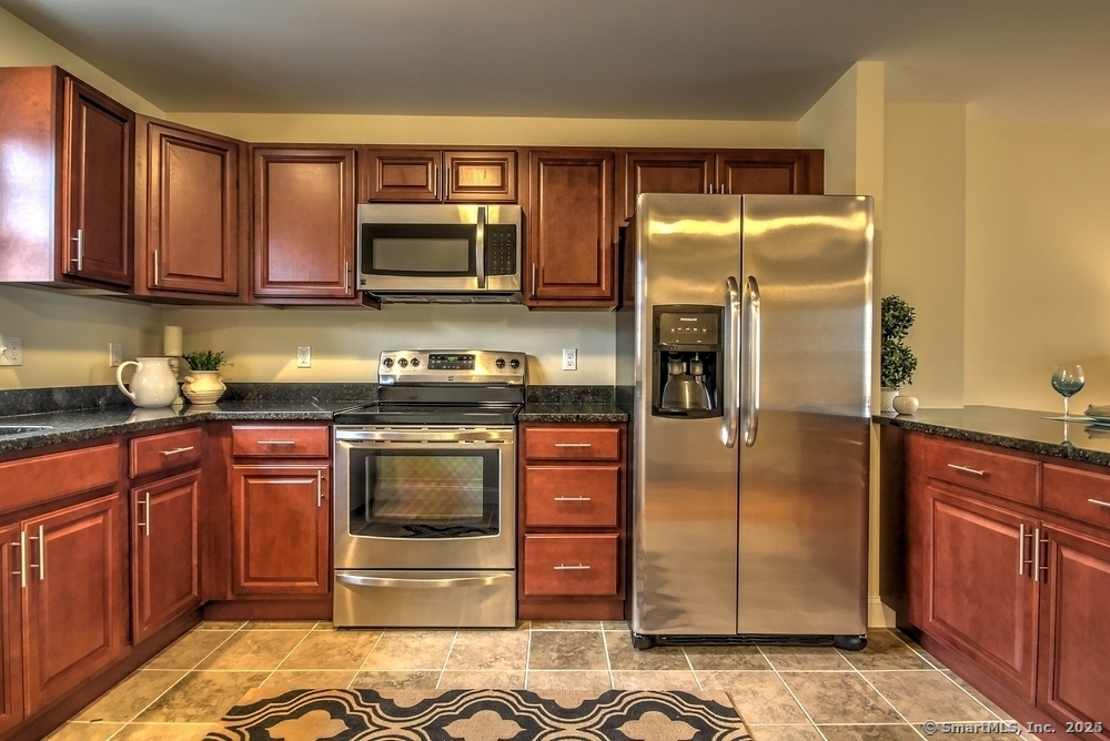 231 West Main Street, Unit C Milford, CT 06460 - Photo 2 of 18 a kitchen with stainless steel appliances granite countertop a refrigerator stove and sink