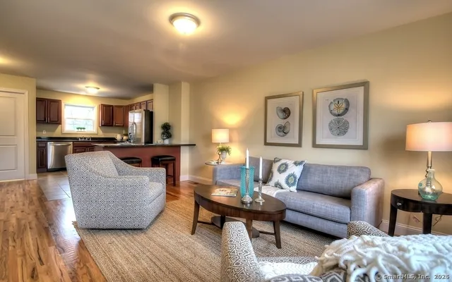 a living room with furniture and a wooden floor