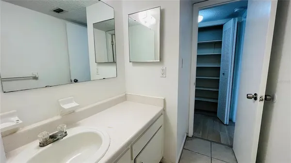 an empty room with closet and a window