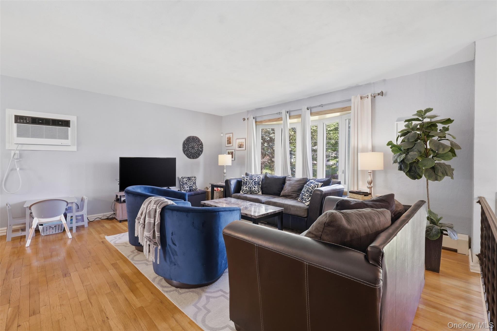 24 Beatty Road Wappingers Falls, NY 12590 - Photo 4 of 36 a living room with furniture a flat screen tv and a large window