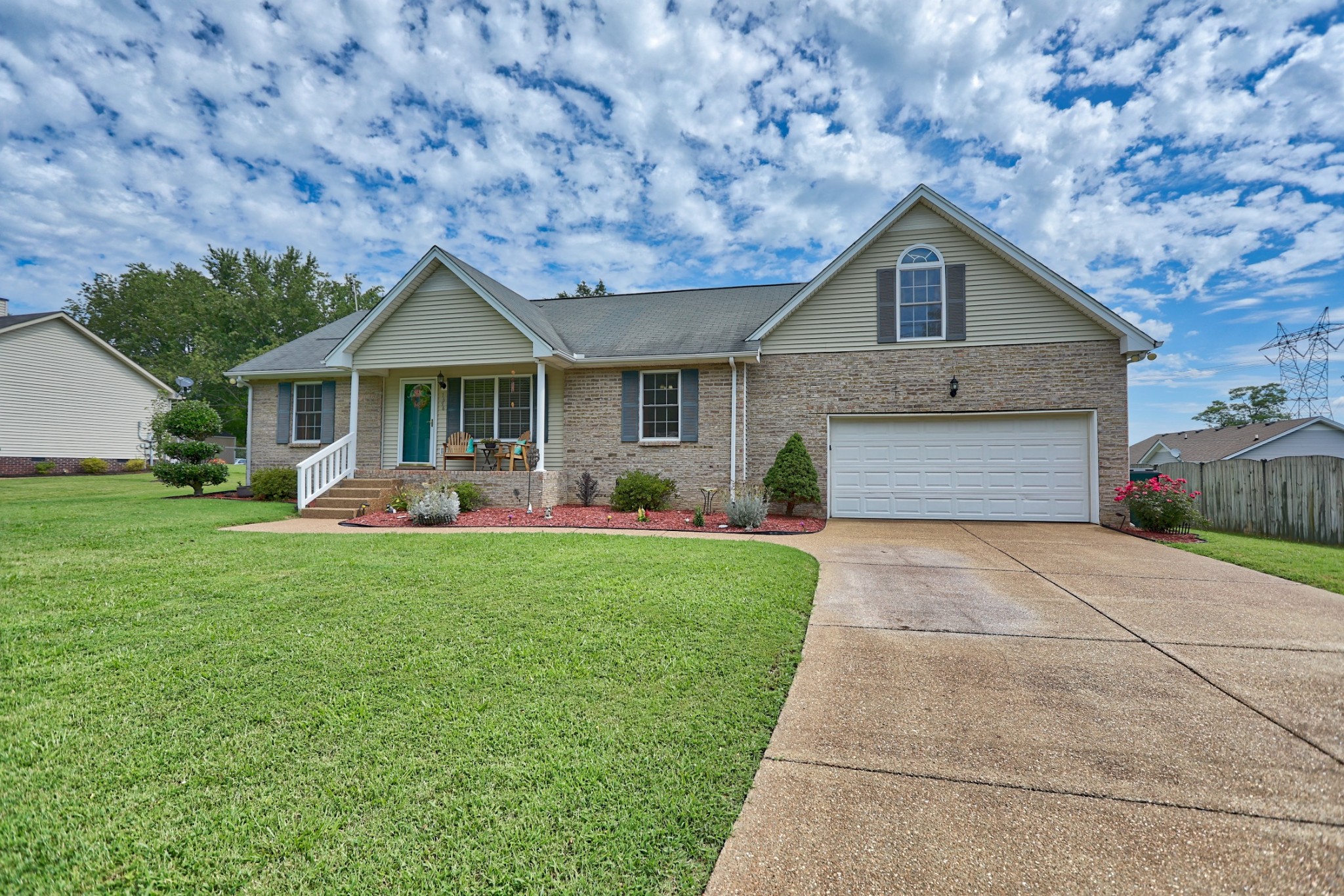 7696 South Swift Road Goodlettsville, TN 37072 - Photo 1 of 31 a front view of a house with garden