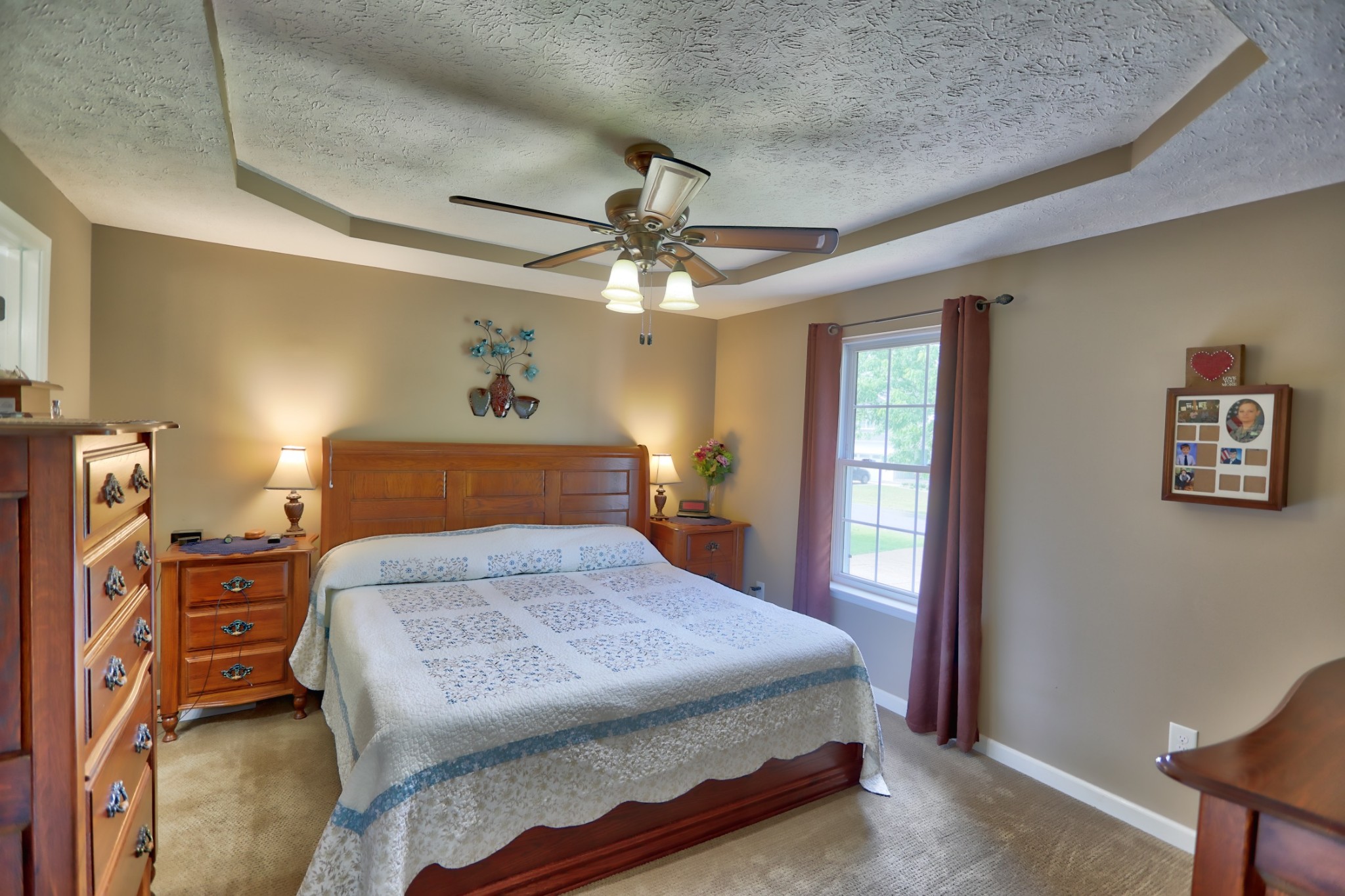 7696 South Swift Road Goodlettsville, TN 37072 - Photo 16 of 31 a bedroom with a bed a dresser and a chandelier