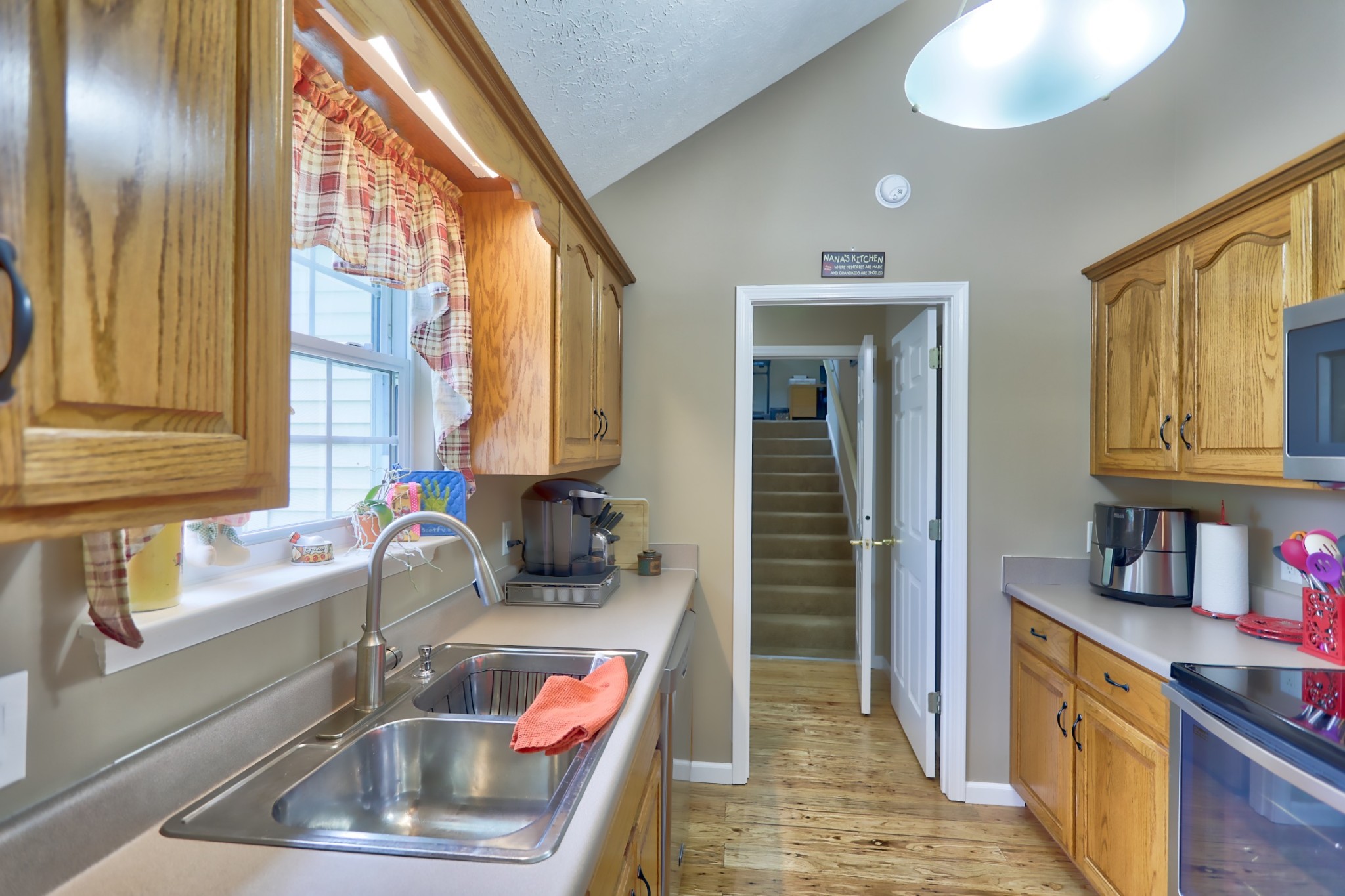 7696 South Swift Road Goodlettsville, TN 37072 - Photo 9 of 31 a kitchen with a sink and a refrigerator