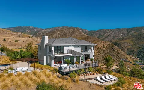 a view of house with outdoor space and swimming pool