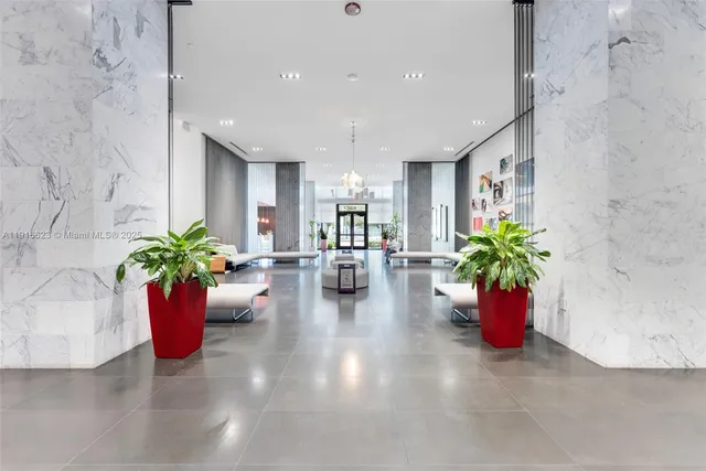 a hallway with a potted plant and a table