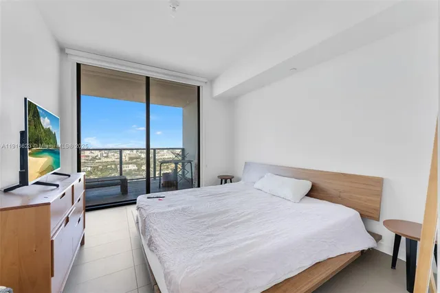 a kitchen with a stove a kitchen island a sink and cabinets