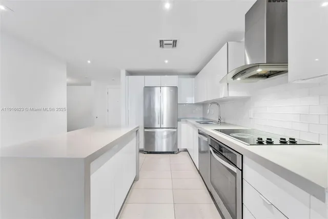 a kitchen with stainless steel appliances granite countertop a sink and a stove