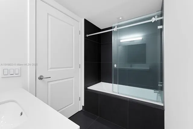 a bathroom with a bathtub and a shower