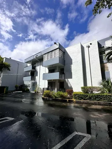 a front view of a house with lake view and boat