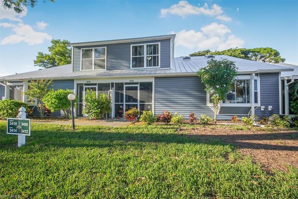 3408 Timberwood Circle, Unit 1360 Naples, FL 34105 - Photo 1 of 36 front view of a house with a yard