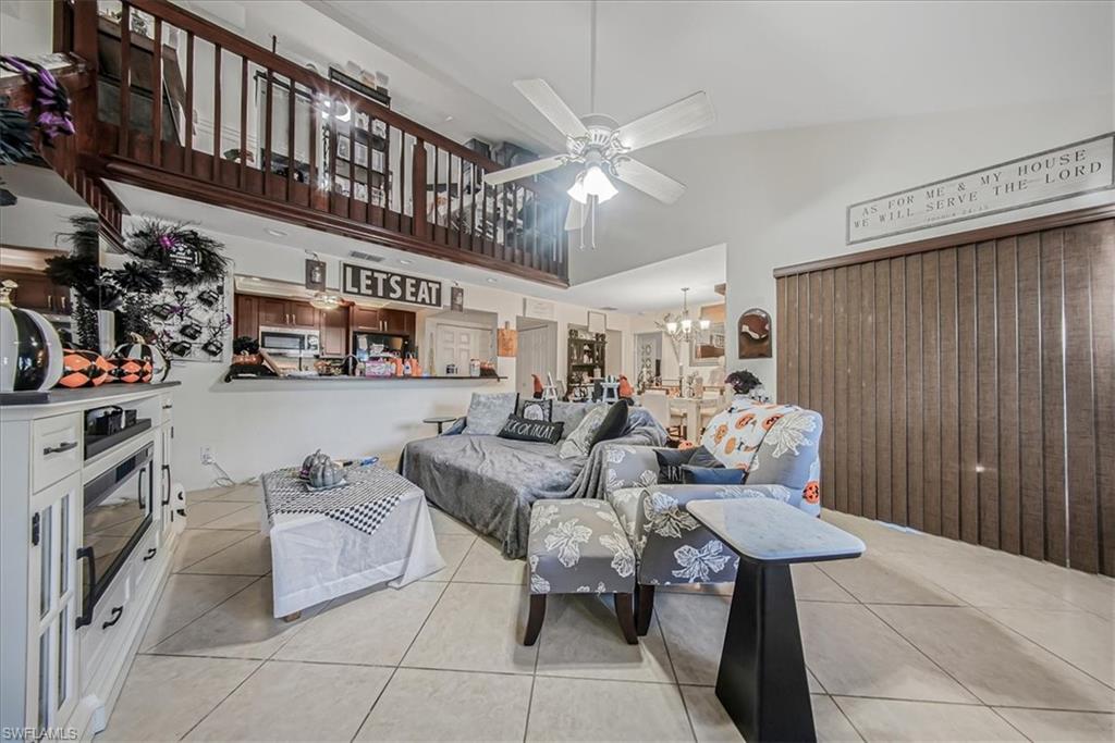 3408 Timberwood Circle, Unit 1360 Naples, FL 34105 - Photo 11 of 36 a living room with furniture and a large window
