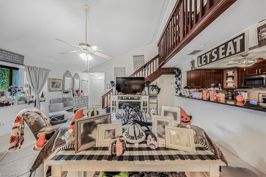 3408 Timberwood Circle, Unit 1360 Naples, FL 34105 - Photo 12 of 36 a view of a kitchen with furniture and a wooden floor