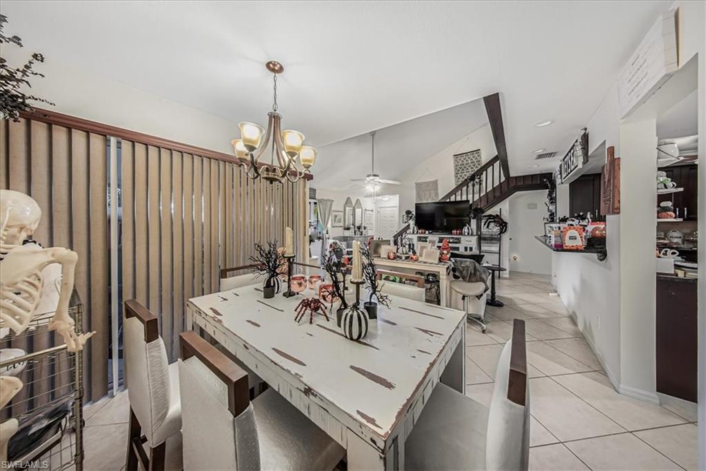 3408 Timberwood Circle, Unit 1360 Naples, FL 34105 - Photo 13 of 36 a view of a dining room with furniture and floor to ceiling window