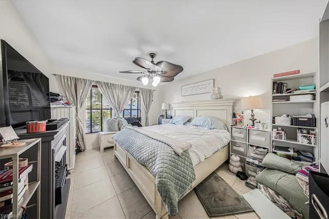 a spacious bedroom with a large bed and a book shelf