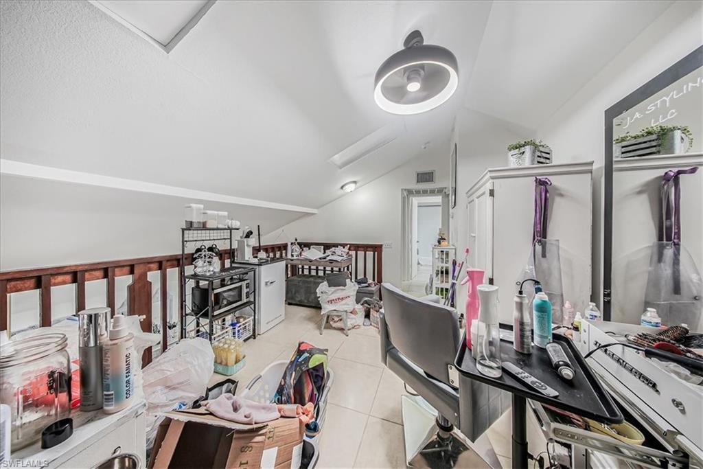 3408 Timberwood Circle, Unit 1360 Naples, FL 34105 - Photo 24 of 36 a view of a room with gym equipment