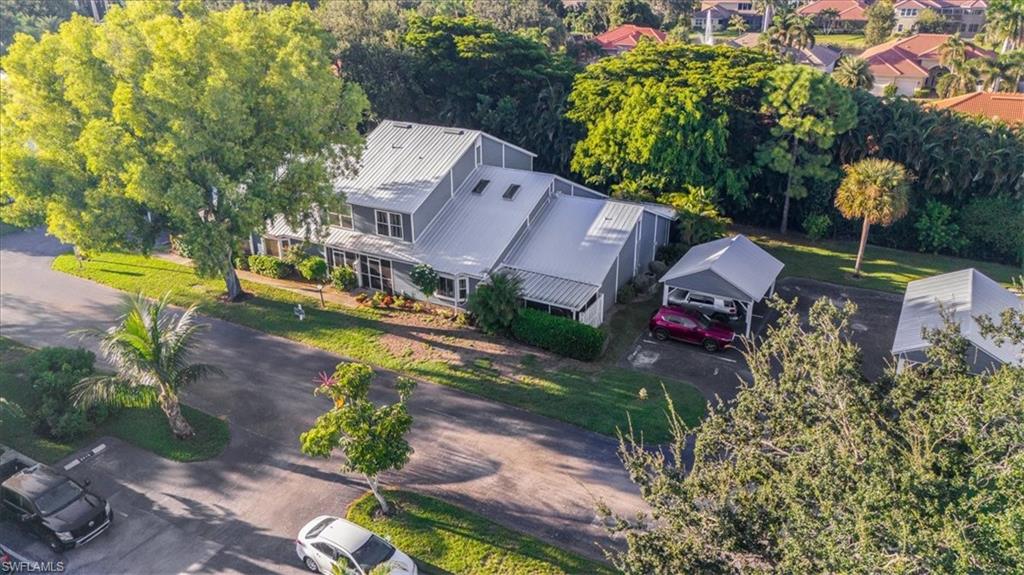 3408 Timberwood Circle, Unit 1360 Naples, FL 34105 - Photo 3 of 36 an aerial view of a house with a yard basket ball court and outdoor seating